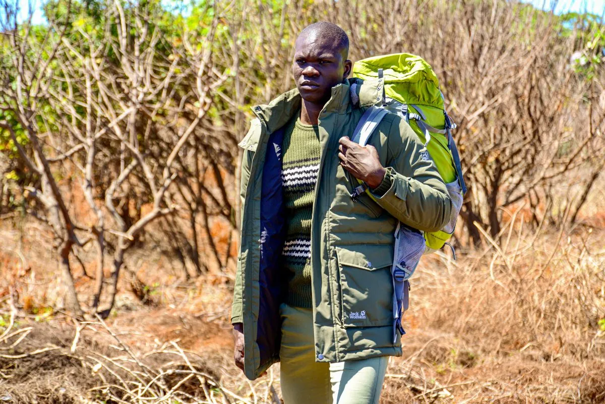 Hiker carrying a backpack on a woodland trail